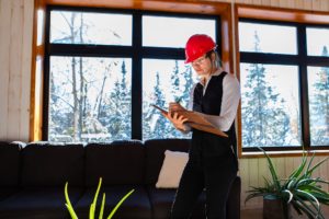 Female Engineer checking air quality in house