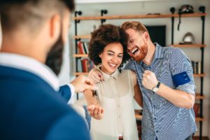 young couple getting keys for their new home