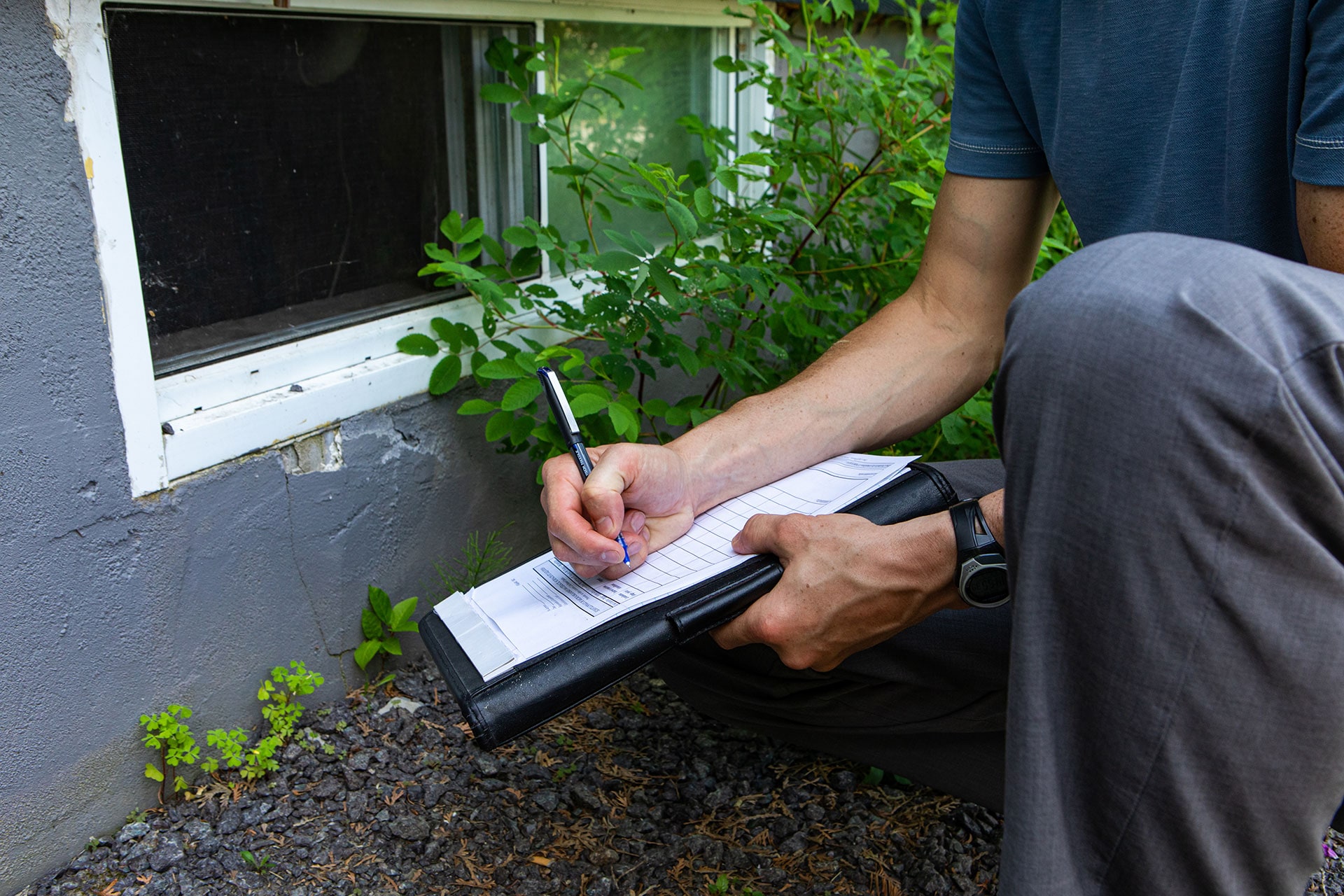 Male Engineer checking damp in house