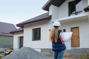 Female Engineer inspecting a house