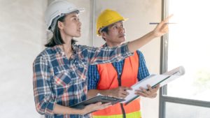 male and female surveyors inspecting a property