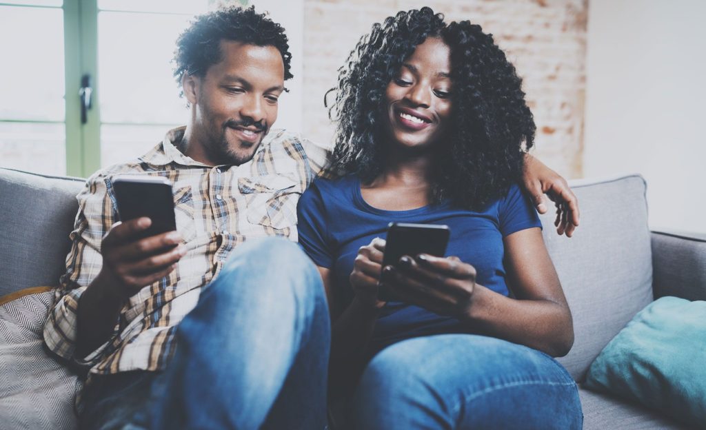 Young couple looking at mobile phones