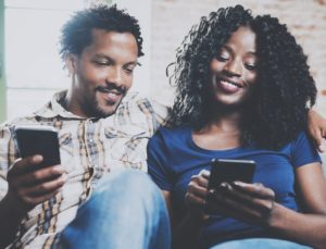 Young couple looking at mobile phones