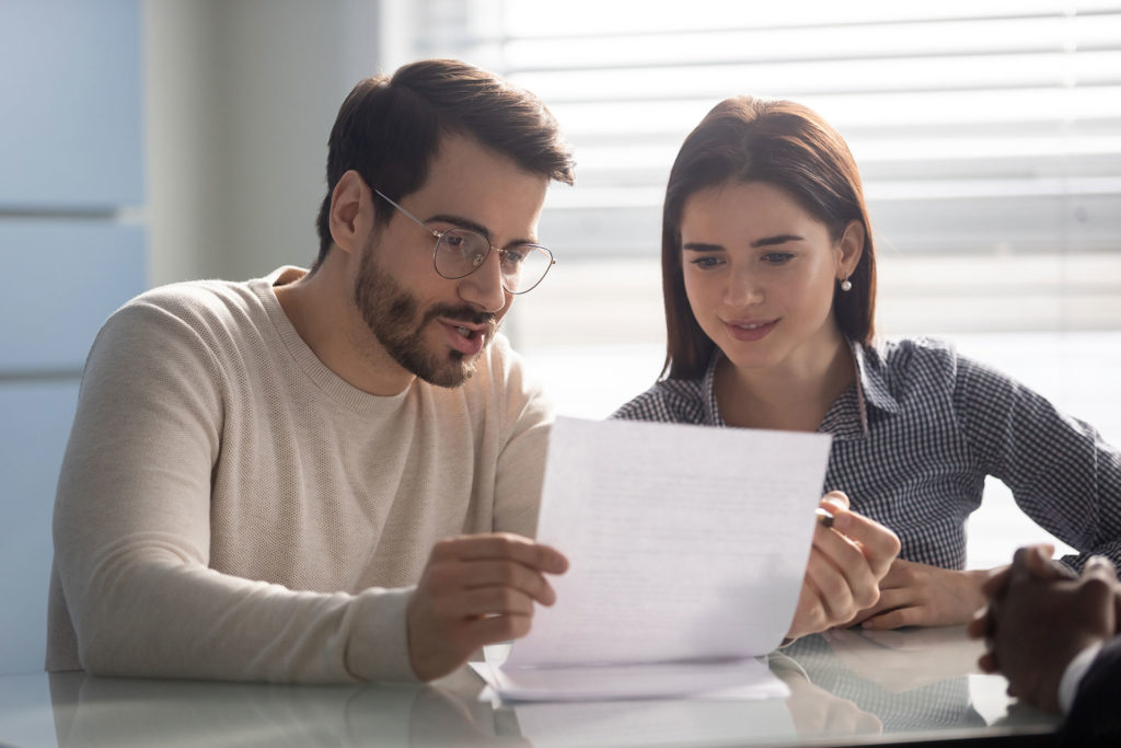 Young couple reading a document