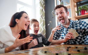 happy family smiling playing a board game