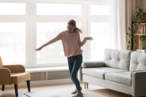 young woman dancing in living room