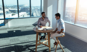 Two men looking at reports in a commercial building