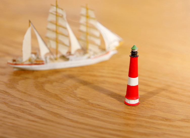 ship and lighthouse on a timber floor