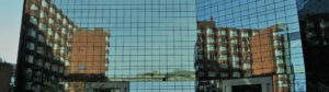 High rise red brick building reflect in glass windows