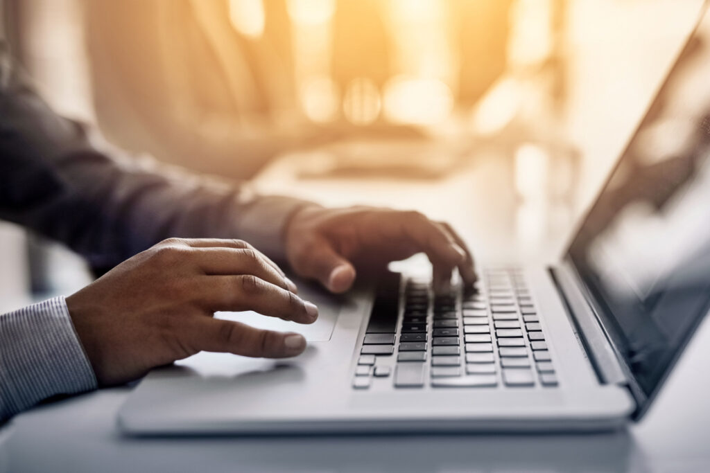 Man typing at laptop