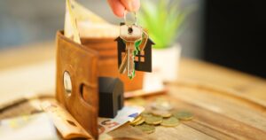 Key with house and euro noters and coins